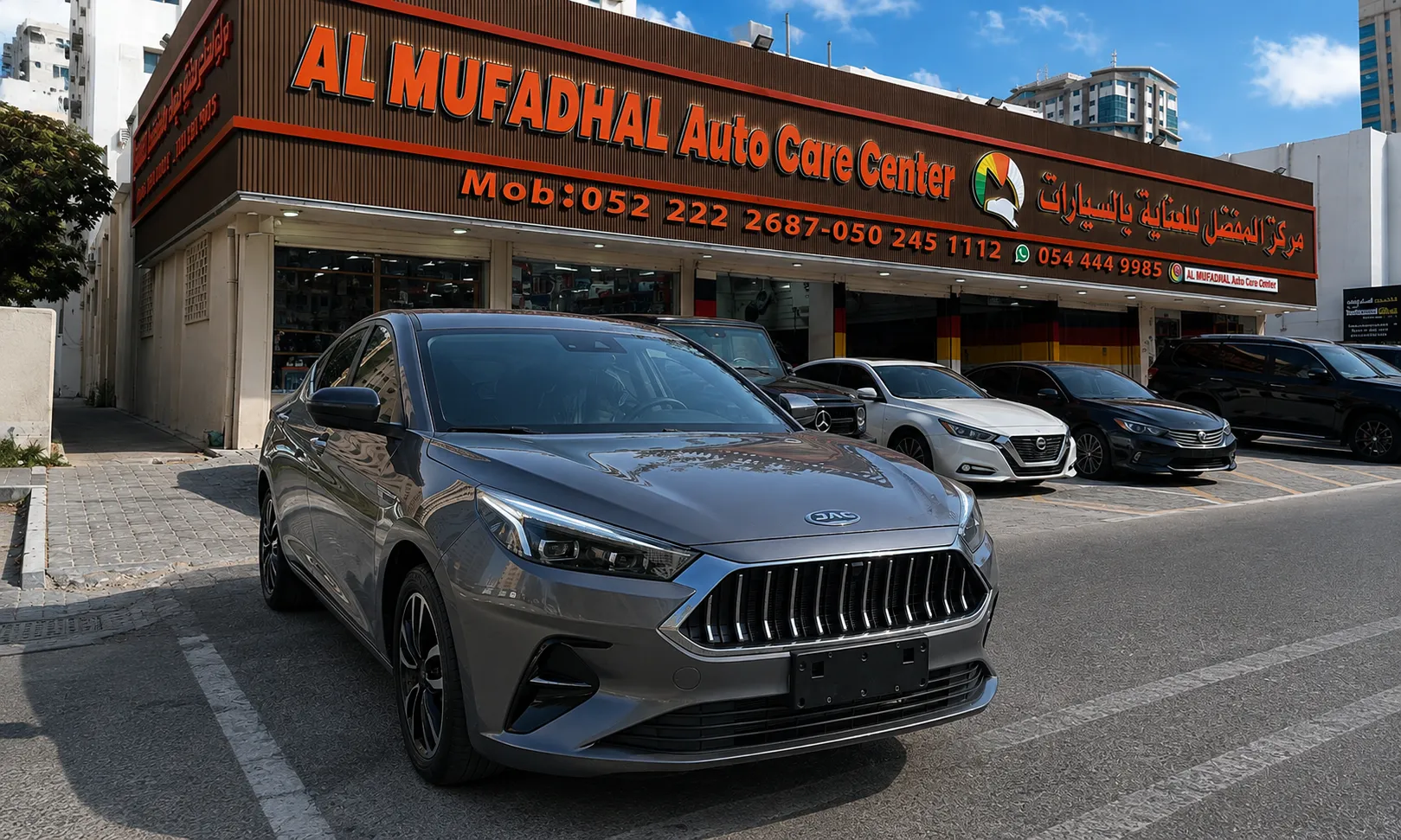 Finished grey sedan outside AL MUFADHAL Auto Care Center