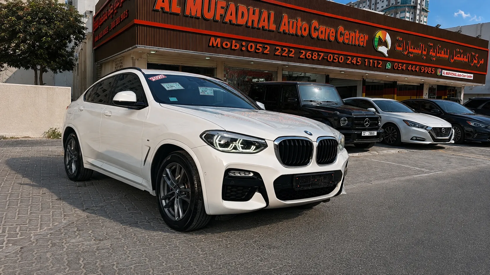 Finished white SUV outside AL MUFADHAL Auto Care Center