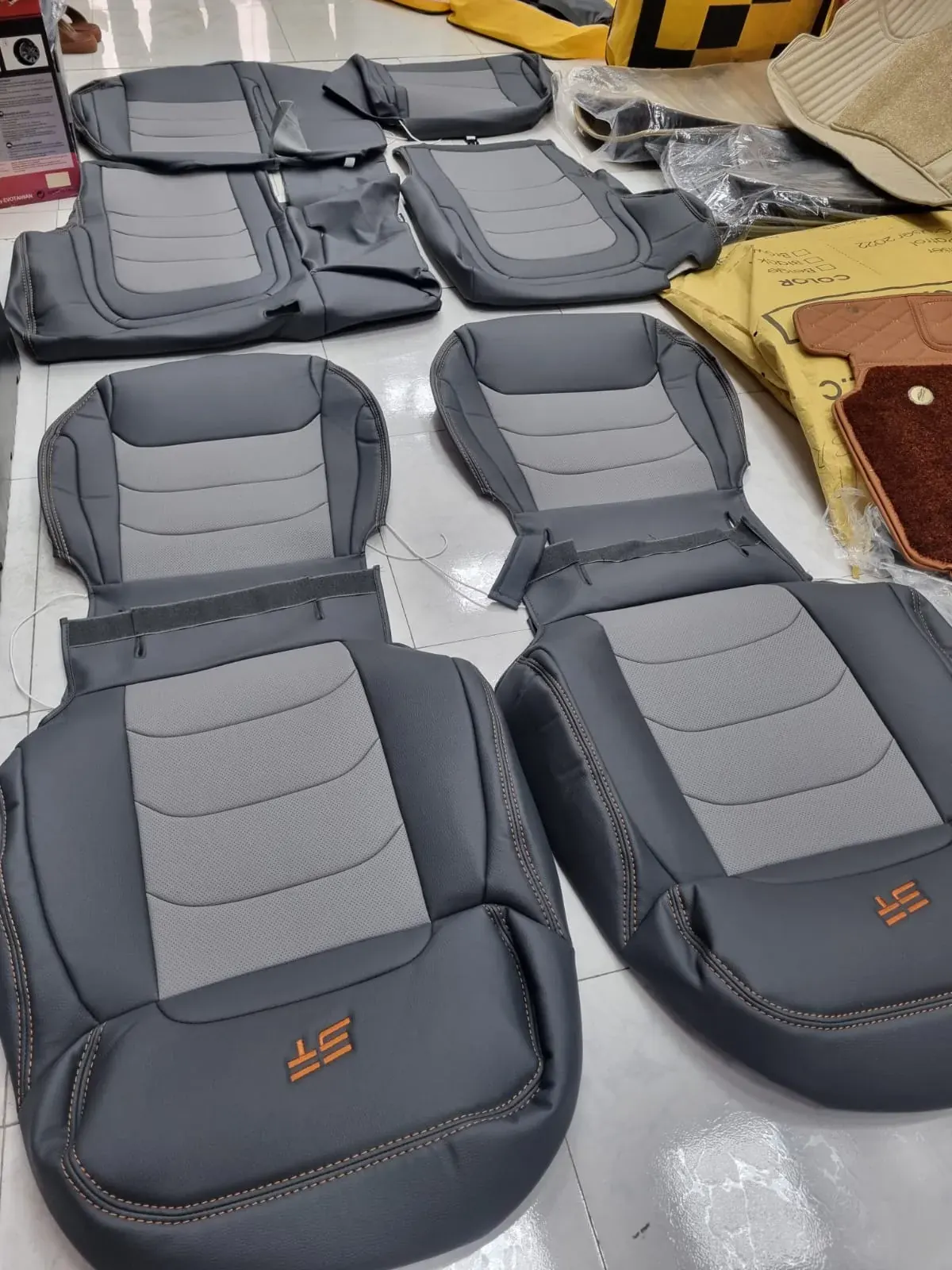 Grey and black stitched seat covers prepared for installation