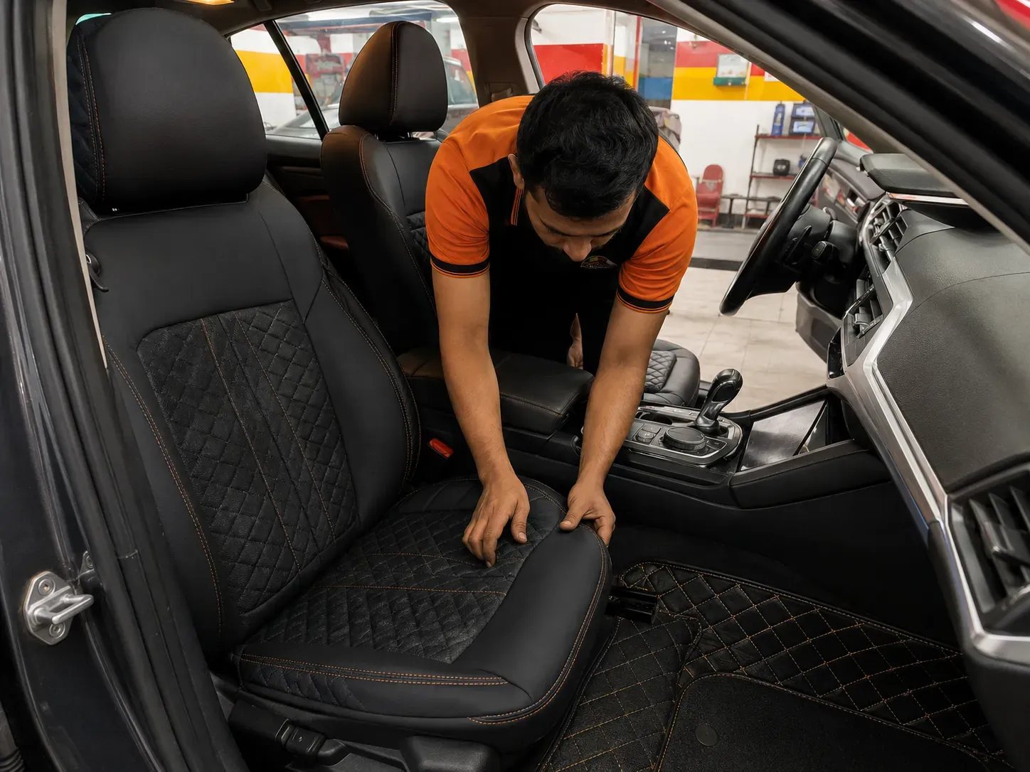 AL MUFADHAL technician fitting a tailored seat cover